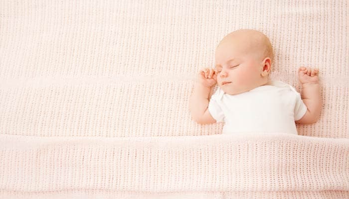 baby sleeping in comfortable sheets