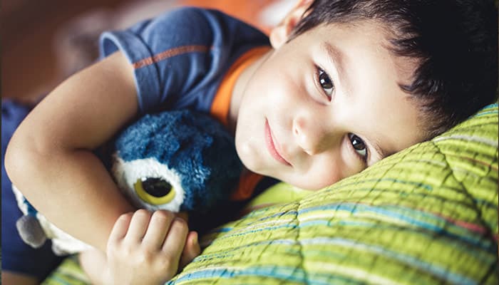 boy lying on bed