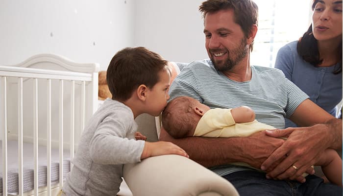 brother meets newborn baby