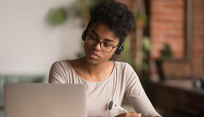 focused woman wearing headphones