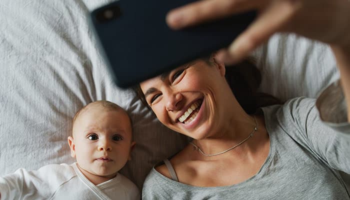 Mother and her newborn taking a selfie