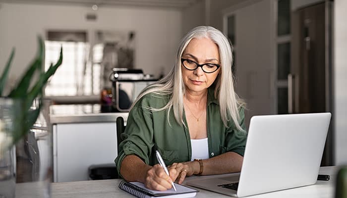 Stylish woman taking notes in a notebook