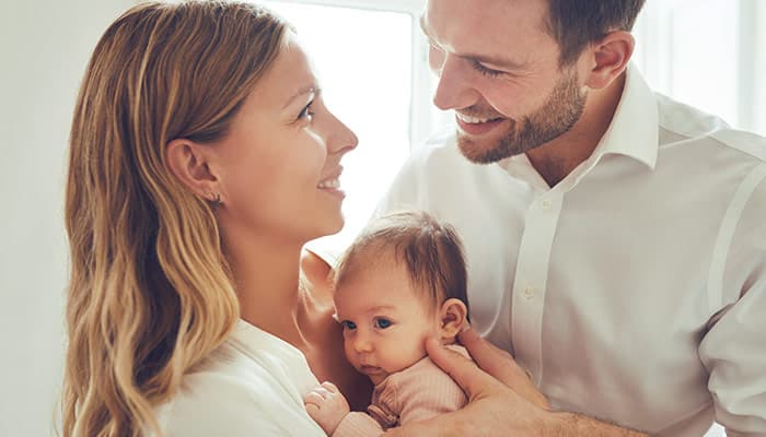 Smiling mother and father with their baby